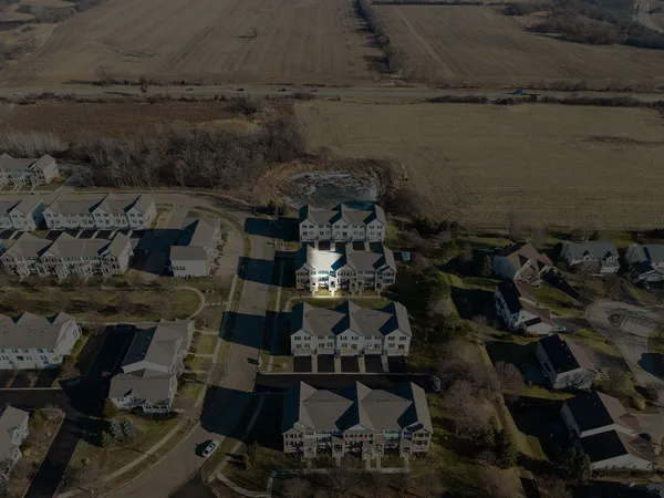 an aerial view of a houses with a yard