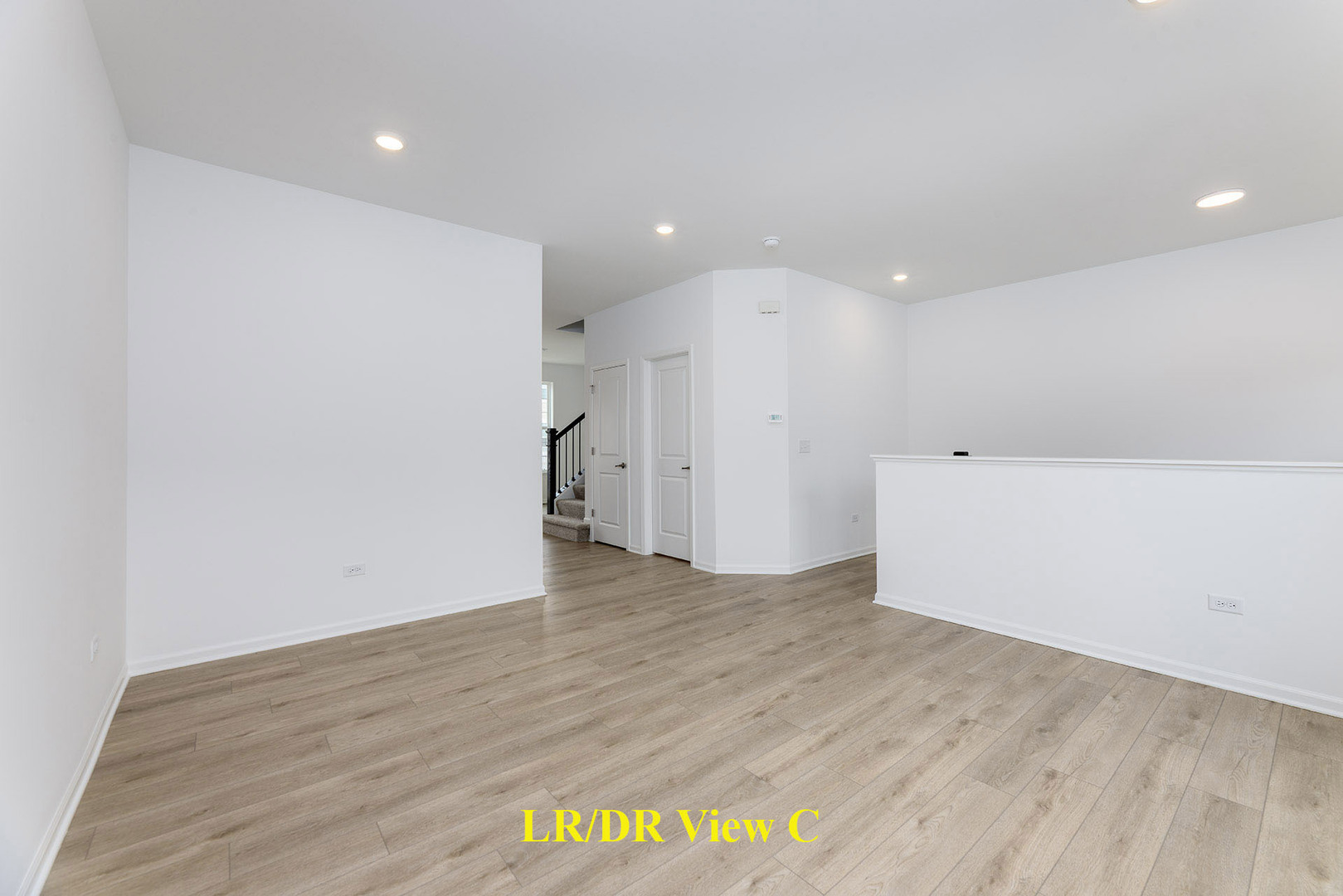 1703 Neubauer Circle Lindenhurst, IL 60046 - Photo 8 of 37 a view of an empty room with wooden floor and a window