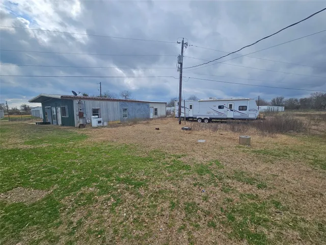 a view of a room with a table and chairs