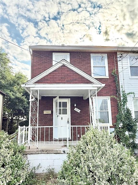 927 Vankirk Street Clairton, PA 15025 - Photo 1 of 8 a front view of a house with a garden