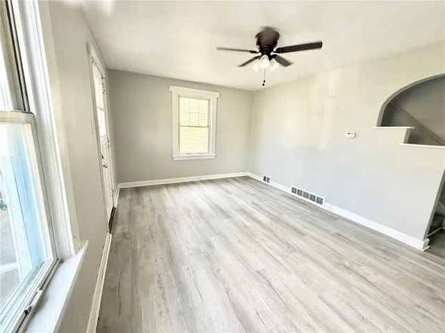 wooden floor in an empty room with a window
