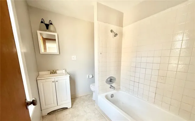 a bathroom with a bathtub sink and toilet