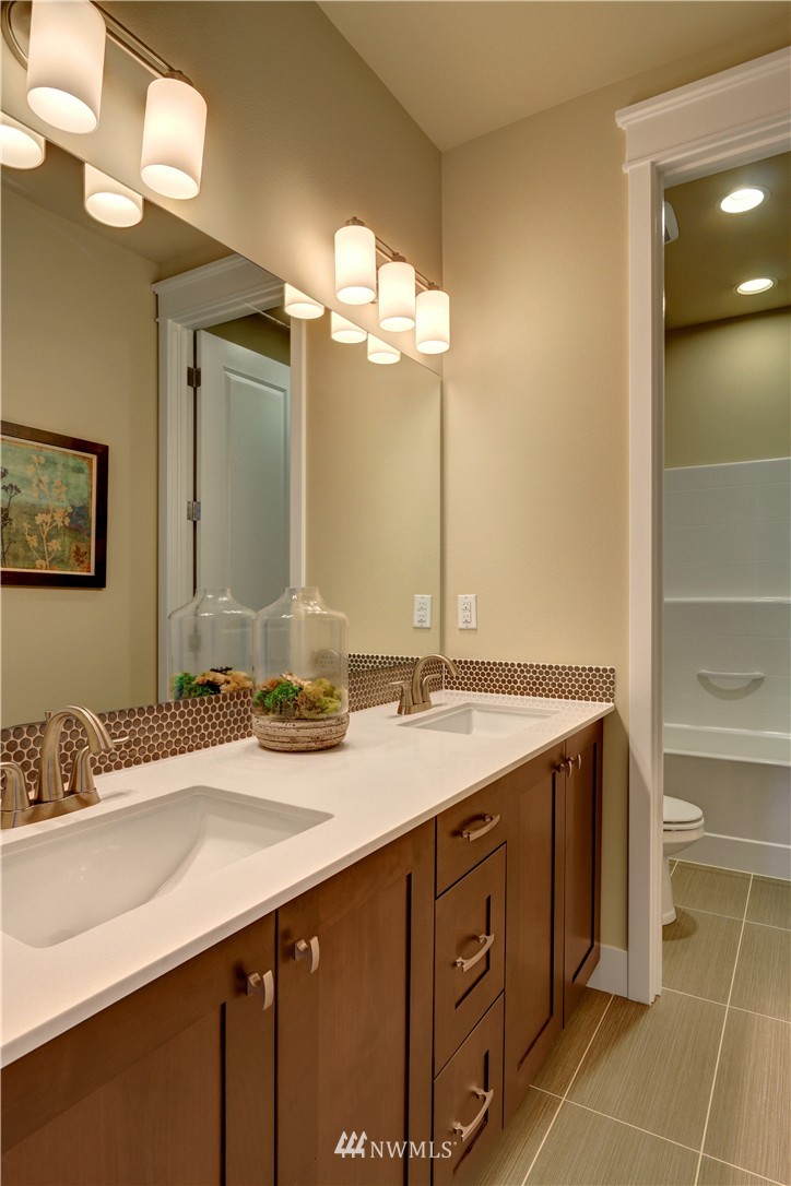 329 Field Place Southeast Renton, WA 98059 - Photo 18 of 19 a bathroom with a granite countertop sink and a mirror