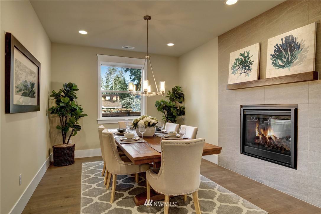 329 Field Place Southeast Renton, WA 98059 - Photo 7 of 19 a dining room with furniture potted plants and wooden floor