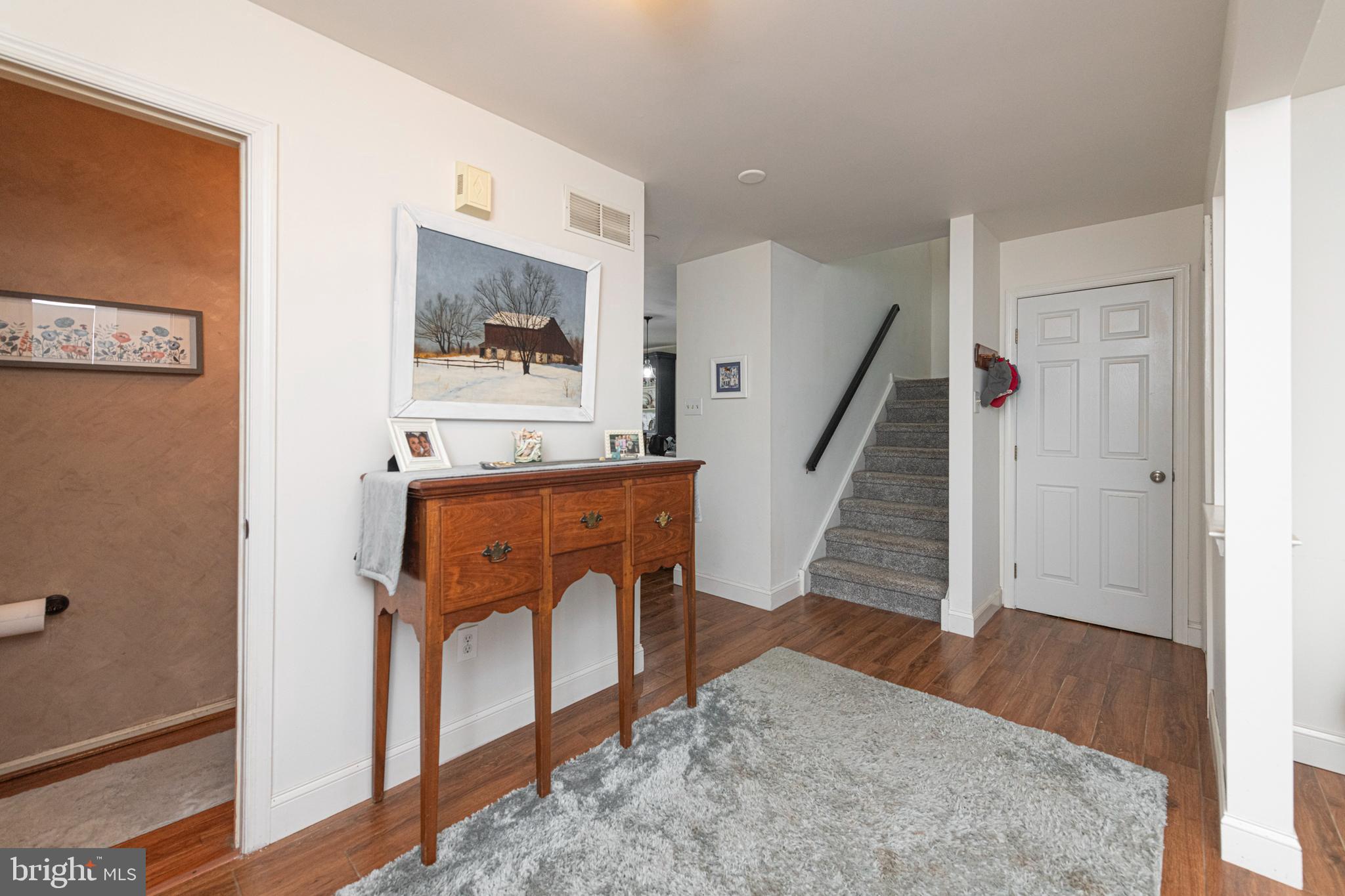 706 Melvin Road Telford, PA 18969 - Photo 4 of 55 a view of a hallway with wooden floor and staircase
