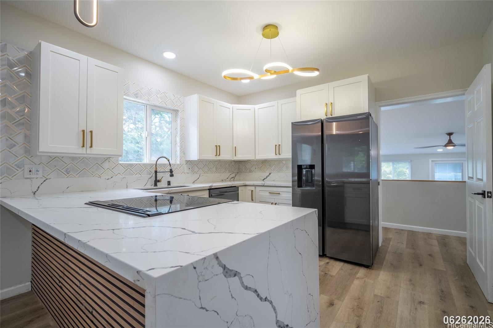 87-1409 Akowai Road Waianae, HI 96792 - Photo 13 of 25 a kitchen with kitchen island a sink appliances and cabinets