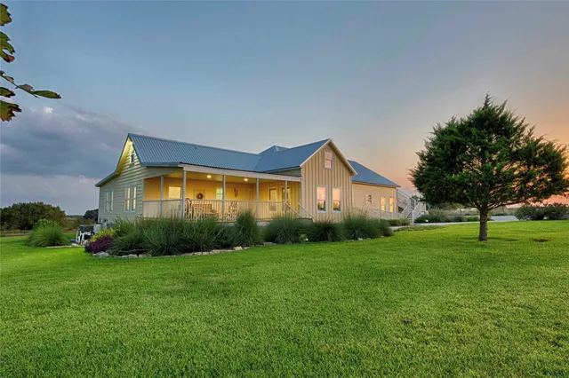 a front view of house with yard and green space