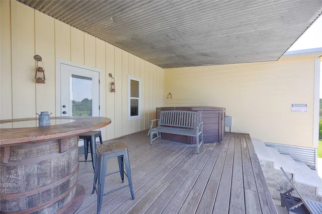a view of a terrace with wooden floor and fence
