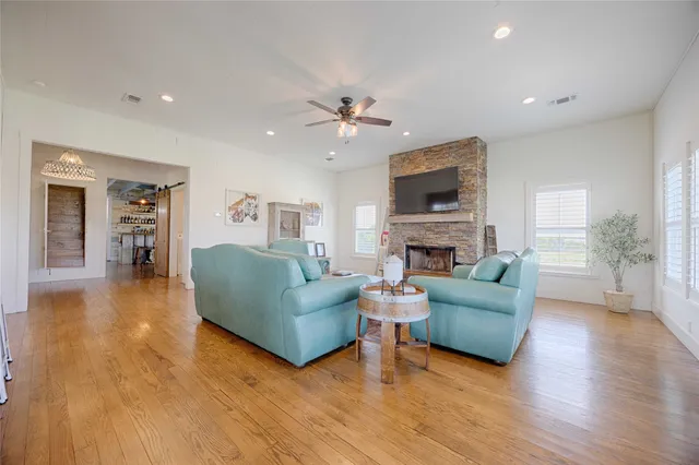 a living room with furniture a fireplace and a large window