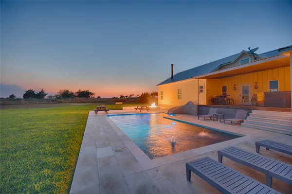 a view of swimming pool with a yard