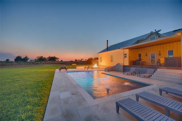 a view of swimming pool with a yard