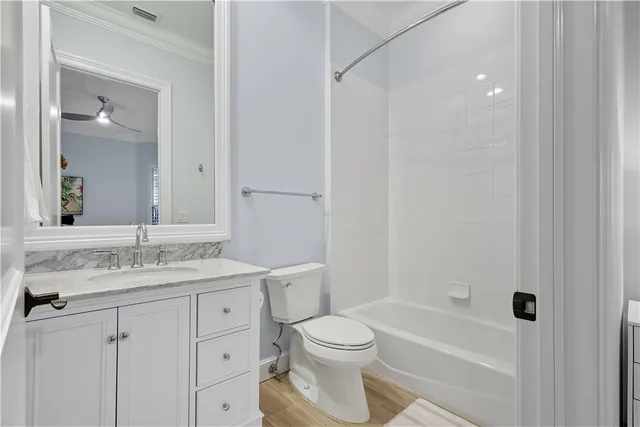 a bathroom with a granite countertop sink toilet a mirror and shower