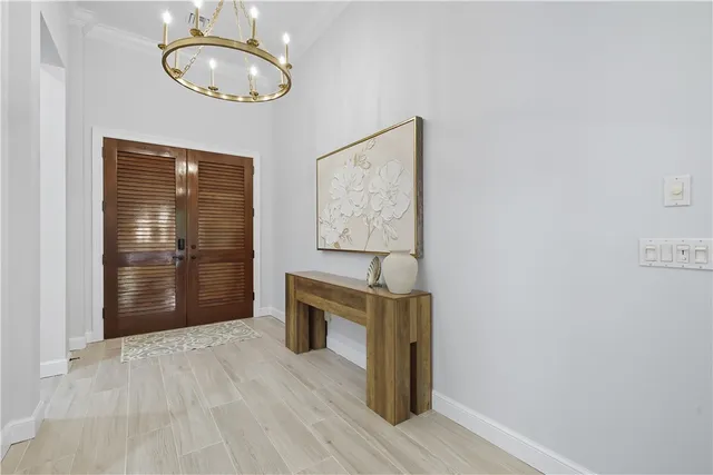 an empty room with wooden floor and mirror