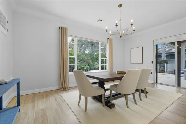 a dining room with furniture window and wooden floor