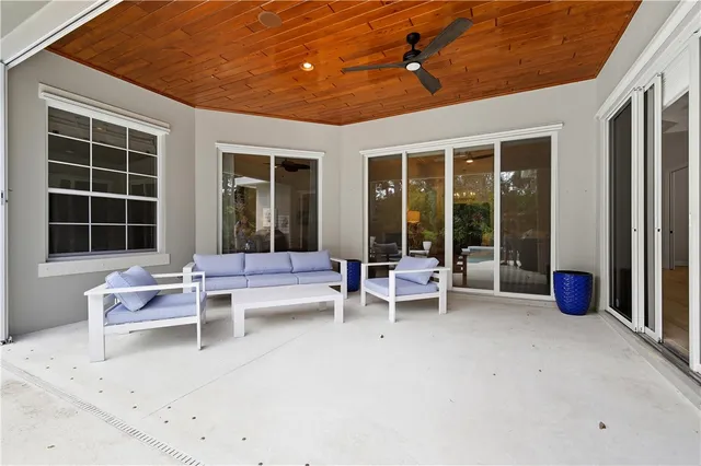 a view of a patio with table and chairs