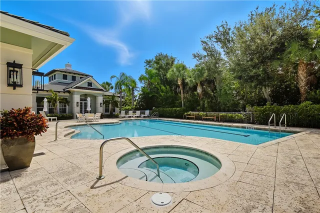 a view of a house with swimming pool and sitting area