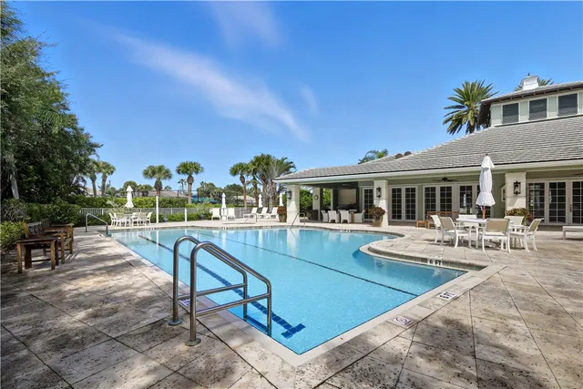 a view of a house with swimming pool and sitting area