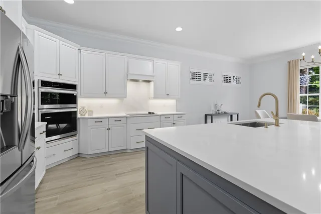 a kitchen with a sink appliances and cabinets