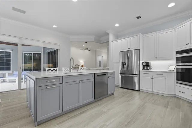 a kitchen with white cabinets and stainless steel appliances