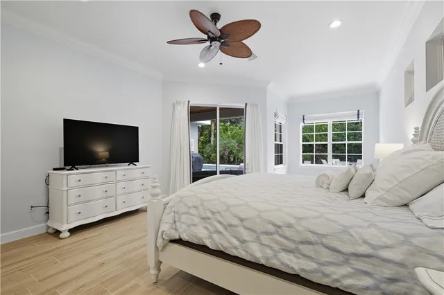 a bedroom with bed tv and window