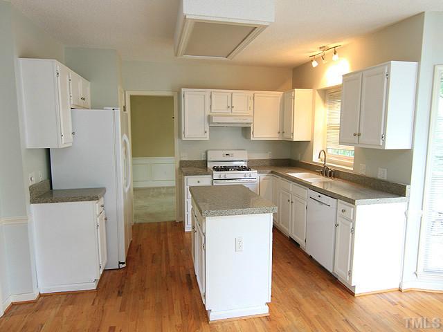 4000 Kettering Drive Durham, NC 27713 - Photo 4 of 12 Kitchen features an island, hardwood floor, and granite countertops.
