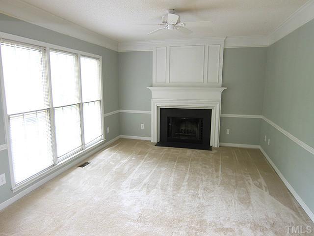 4000 Kettering Drive Durham, NC 27713 - Photo 6 of 12 Tons of natural light in this family room that features a fireplace and ceiling fan.