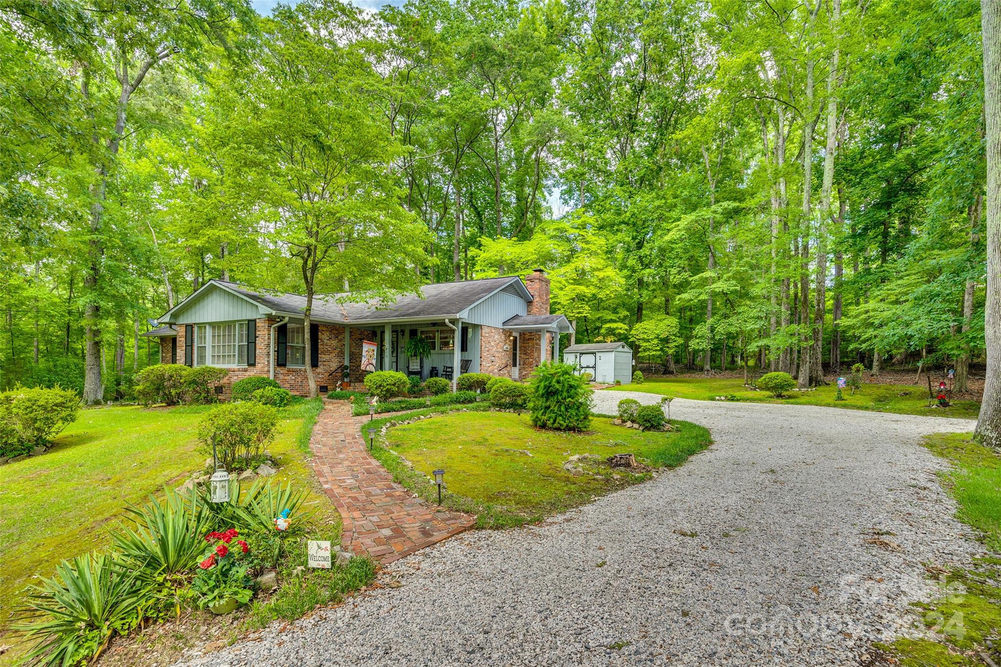 a front view of a house with yard and green space