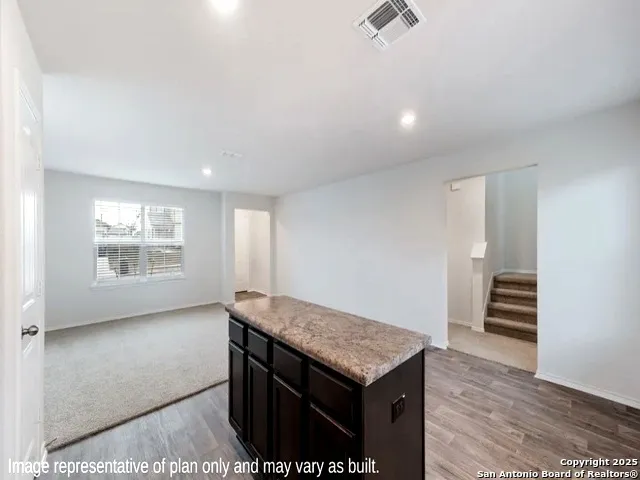 a view of kitchen island with wooden floor