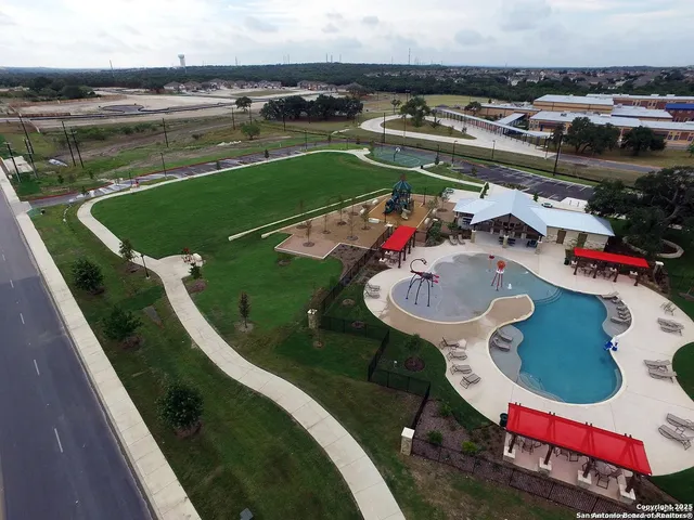 a view of a swimming pool with outdoor seating