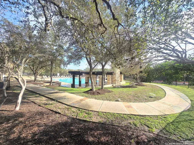a view of a playground ground and trees