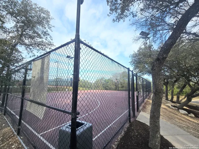 a view of balcony with wooden floor and fence