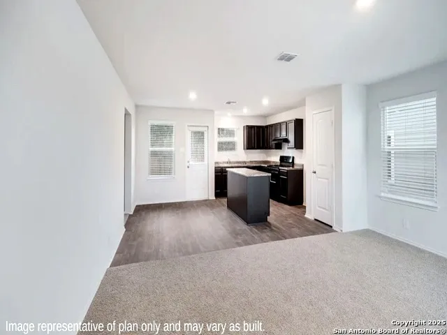 a view of a kitchen with microwave and cabinets