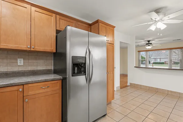 a kitchen with stainless steel appliances granite countertop a refrigerator and a sink