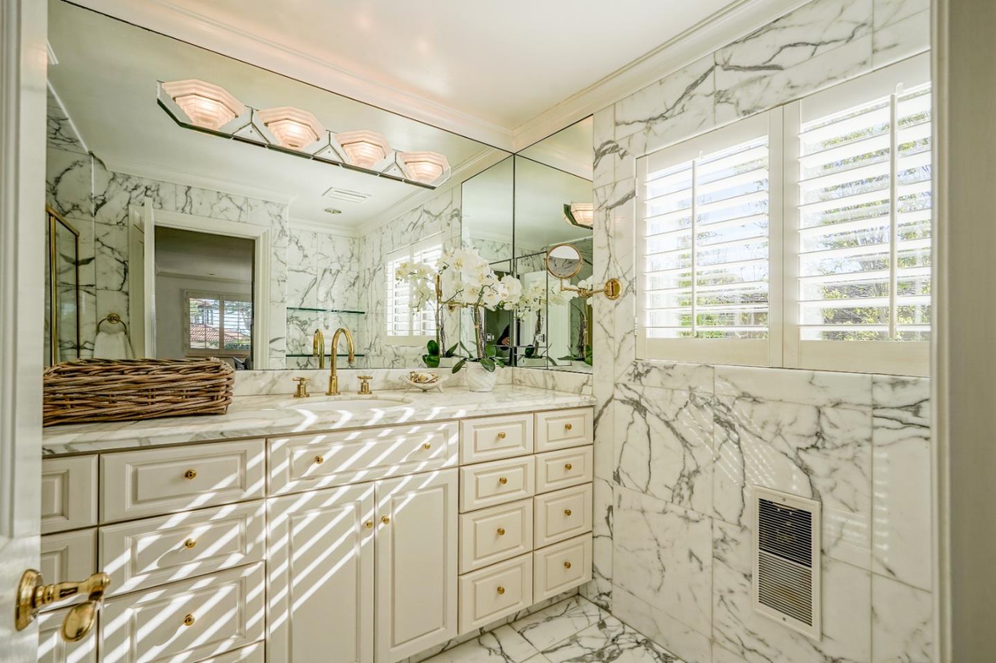 1023 Rodeo Road Pebble Beach, CA 93953 - Photo 26 of 32 a spacious bathroom with double vanity and a mirror