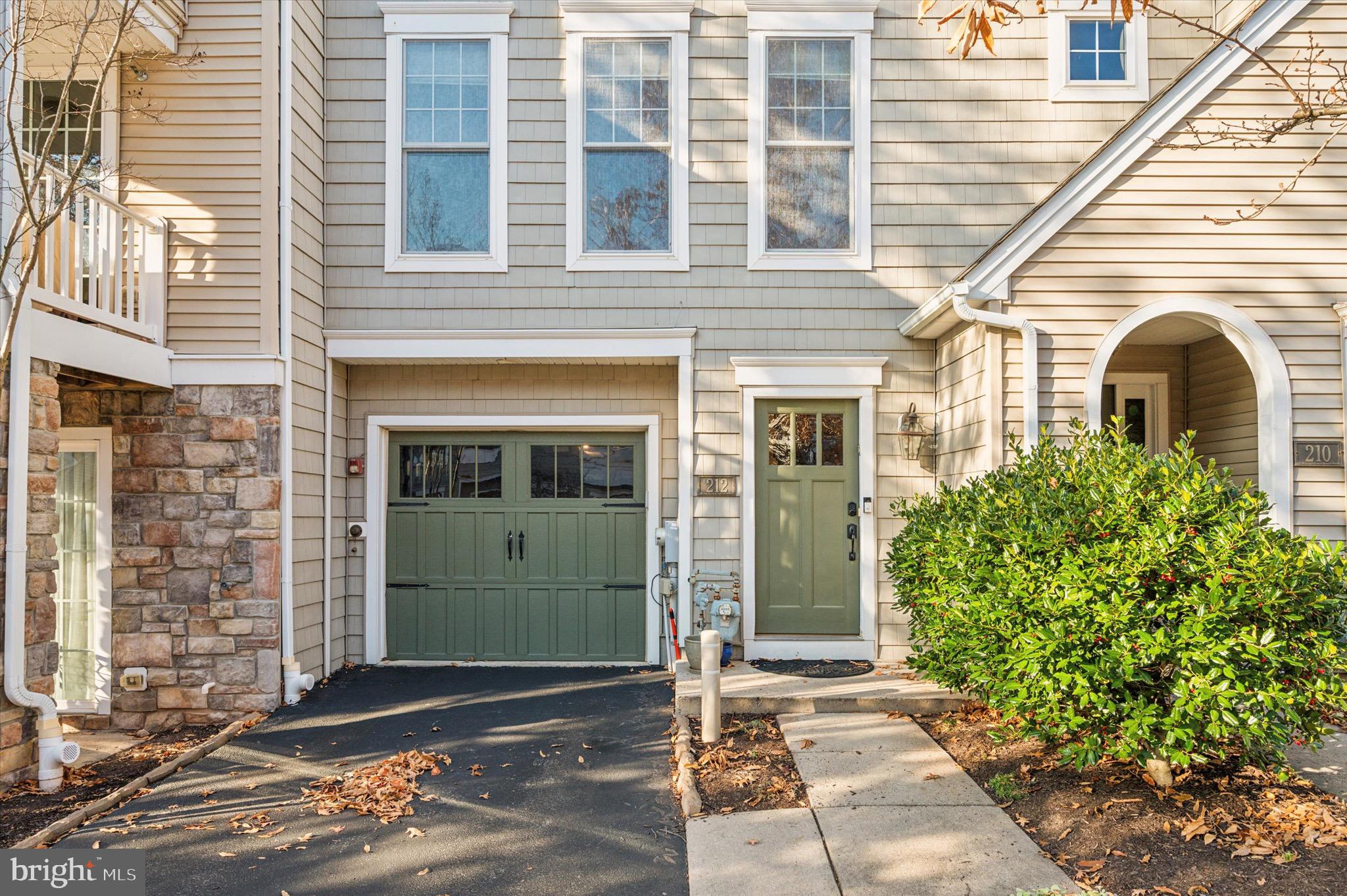 212 Cobblestone Drive Ardmore, PA 19003 - Photo 2 of 15 a front view of a house with a garden
