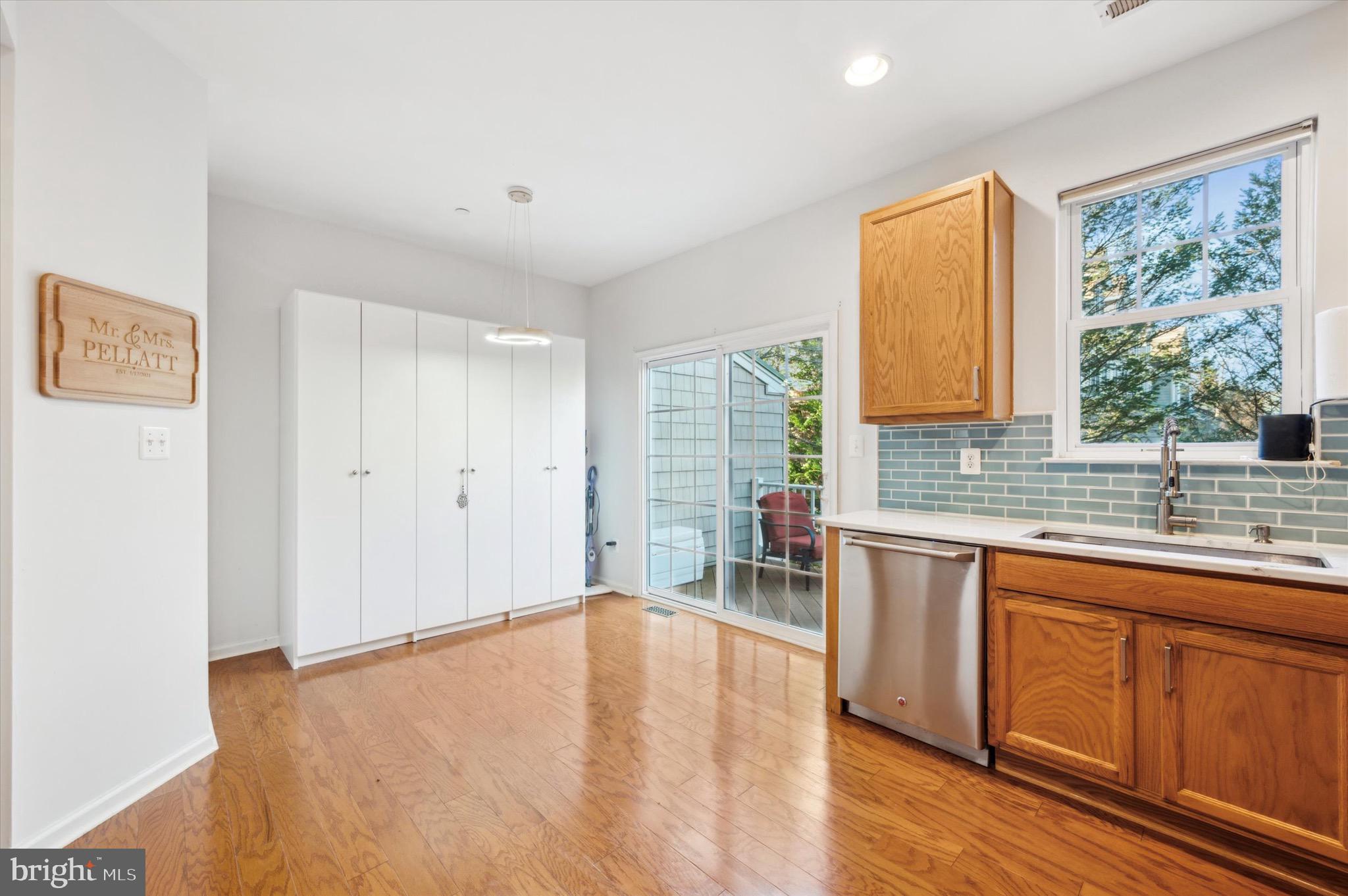 212 Cobblestone Drive Ardmore, PA 19003 - Photo 5 of 15 a large white kitchen with wooden floor and a window