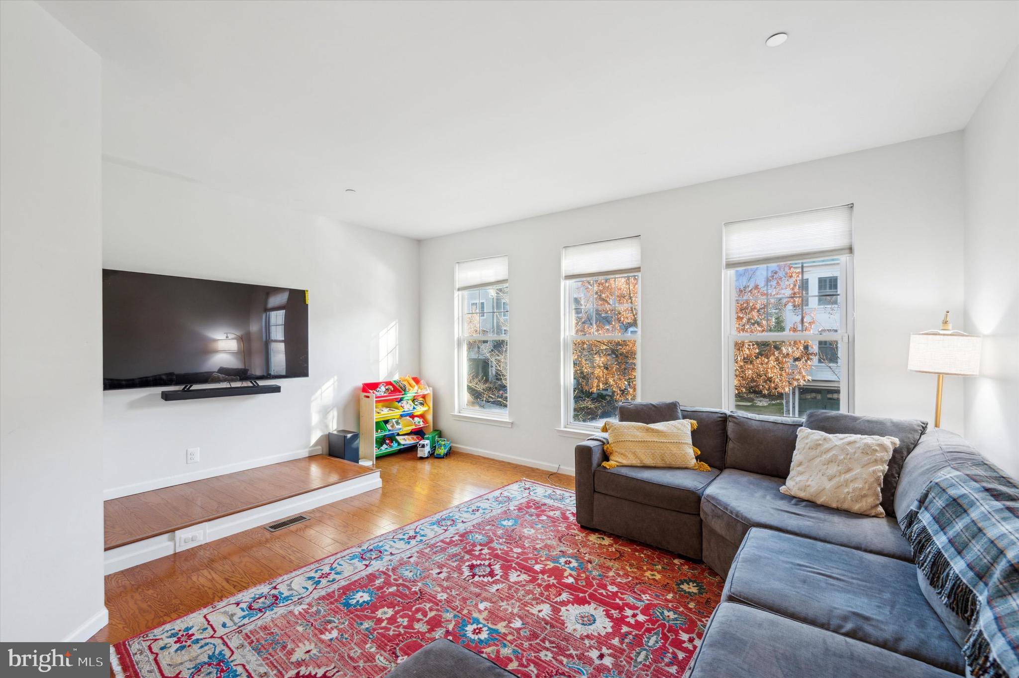212 Cobblestone Drive Ardmore, PA 19003 - Photo 8 of 15 a living room with furniture and a flat screen tv
