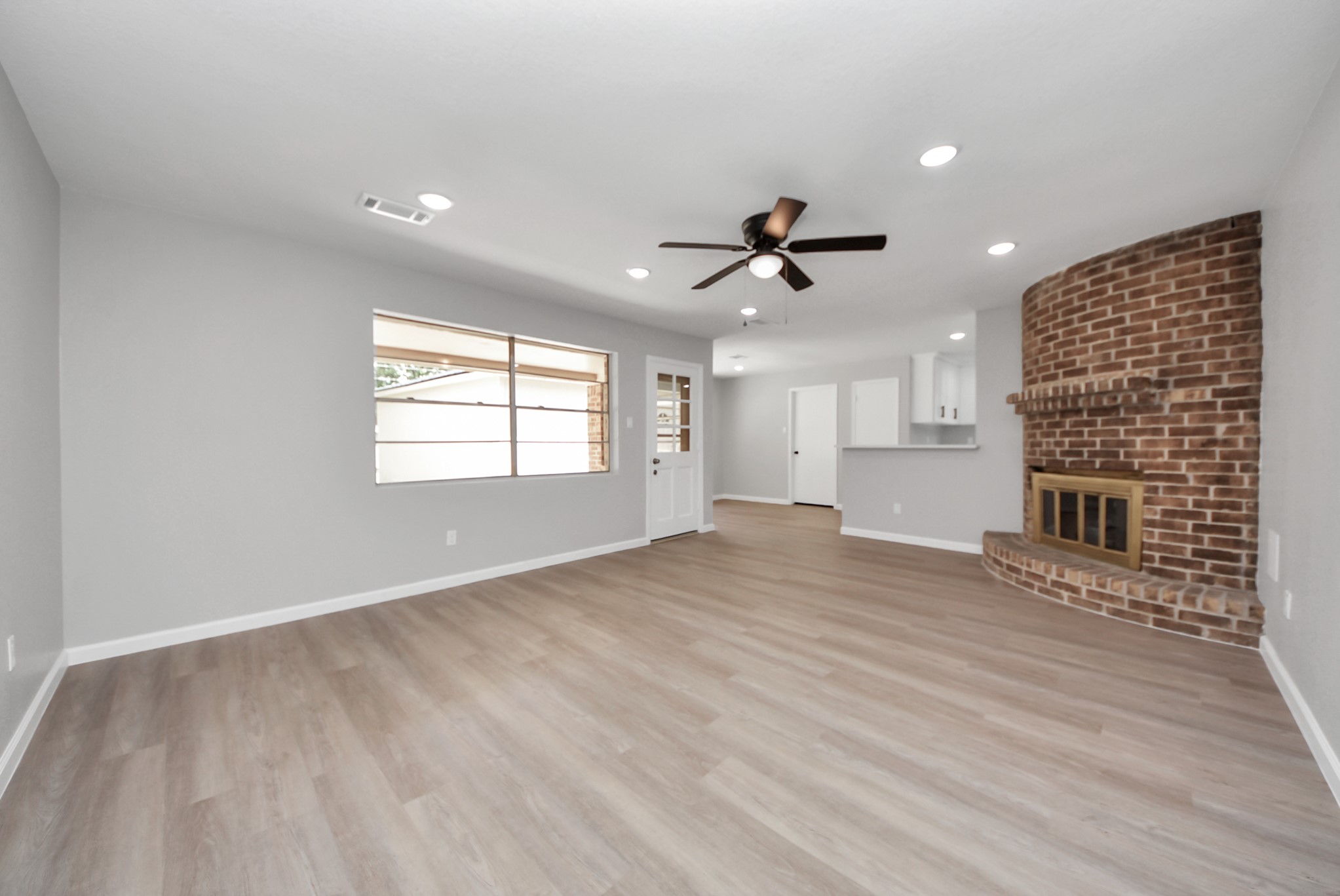 2402 Rolling Glen Drive Spring, TX 77373 - Photo 5 of 38 a view of an empty room with a window and wooden floor