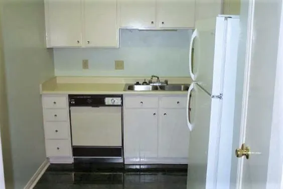 a kitchen with stainless steel appliances a refrigerator and cabinets
