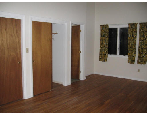 46 High Point Drive Amherst, MA 01002 - Photo 12 of 14 a view of an empty room with wooden floor and windows