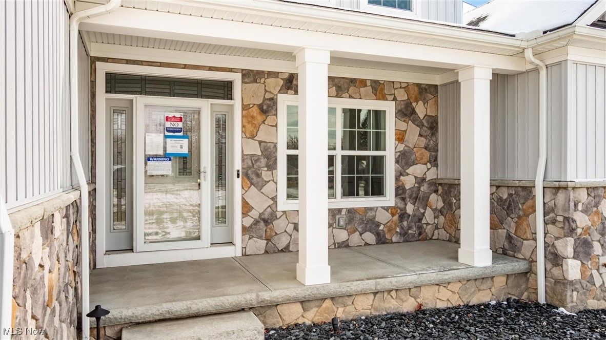 4641 Foote Road Medina, OH 44256 - Photo 7 of 46 Entrance to property with stone siding, a porch, and board and batten siding
