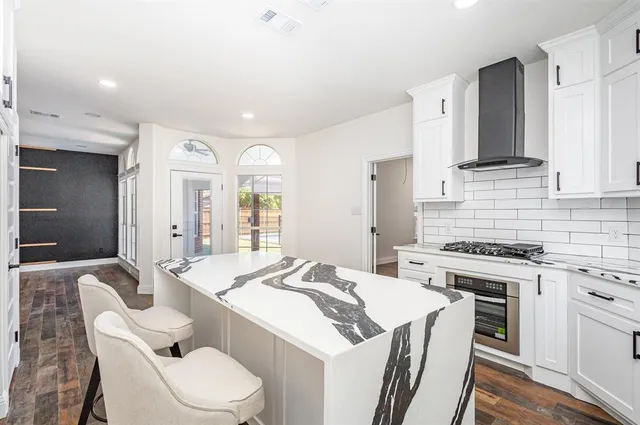 a kitchen with a stove a sink and a refrigerator