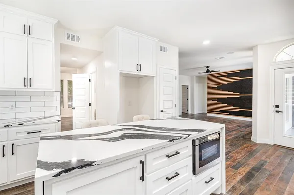 a kitchen with granite countertop a stove and a sink