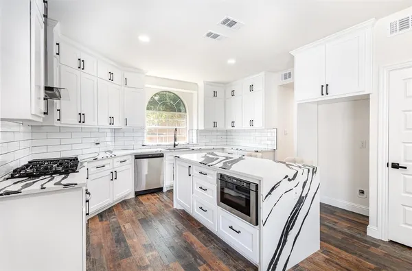 a kitchen with white cabinets sink and white appliances