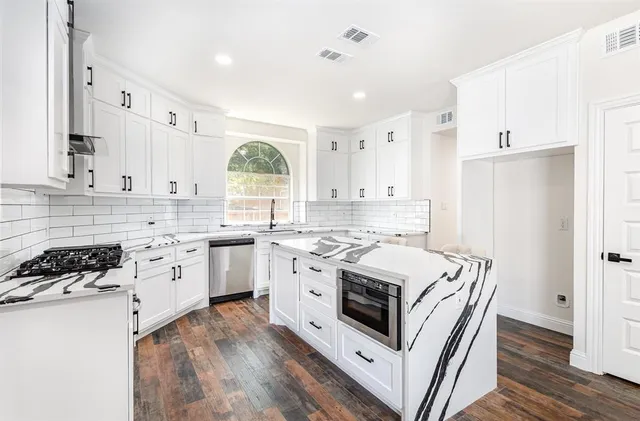 a kitchen with white cabinets sink and white appliances