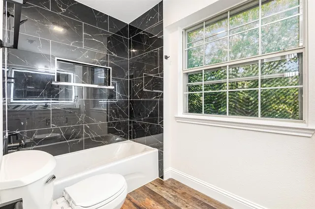 a bathroom with a toilet a sink and bathtub