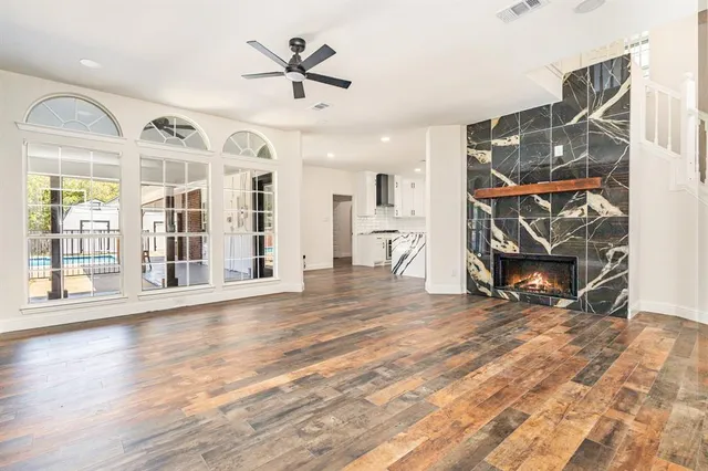 a view of a livingroom with wooden floor and a ceiling fan