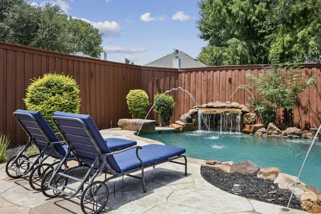 a view of a backyard with sitting area furniture and garden