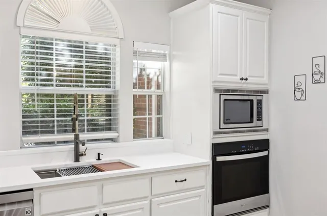 a kitchen with granite countertop a sink and a window