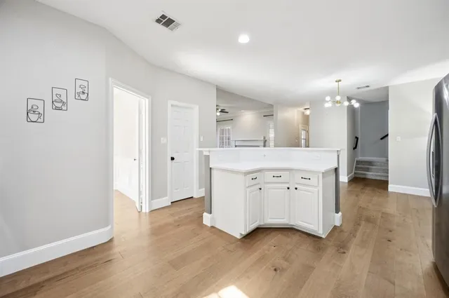 a large white kitchen with a sink a refrigerator and a stove